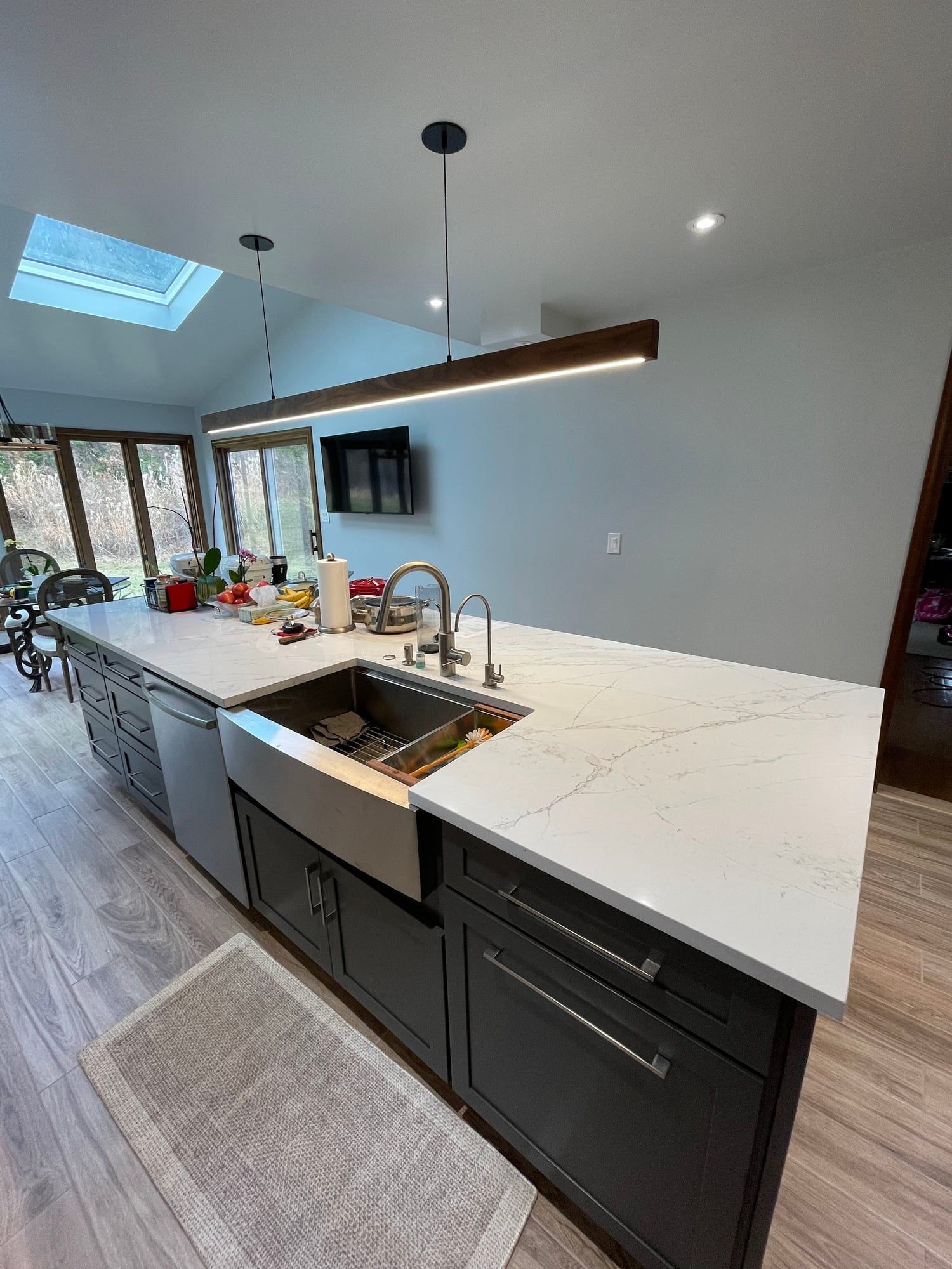 Stainless farmhouse sink set into a quartz-topped island