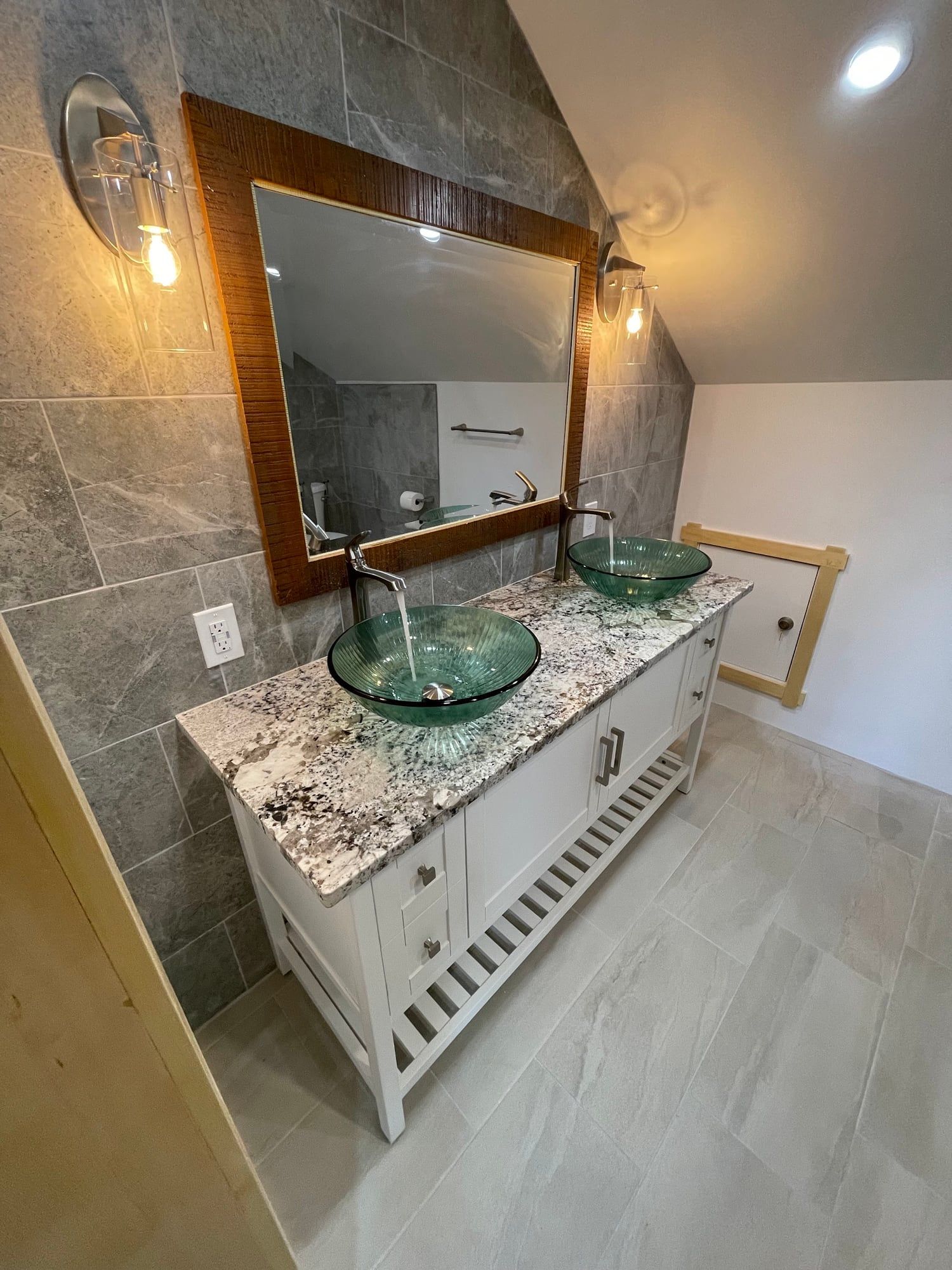 White furniture-style vanity with granite top and twin glass vessel sinks
