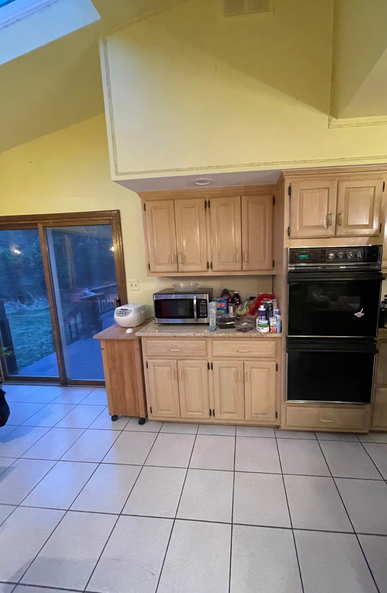 Before: honey oak cabinets and a black double wall oven