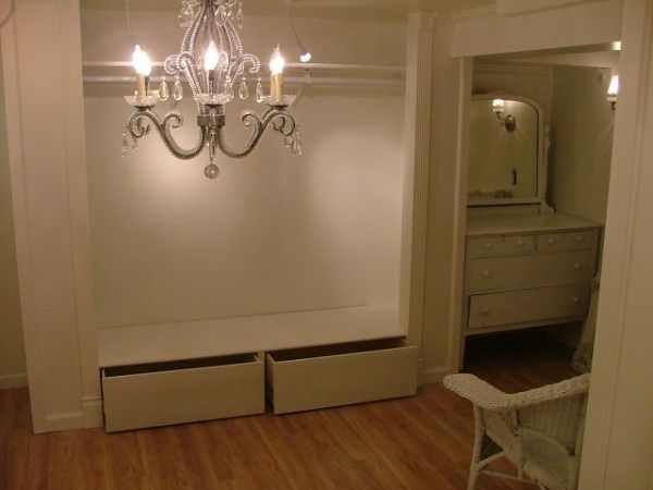 Recessed alcove with a chandelier and two pull-out drawers
