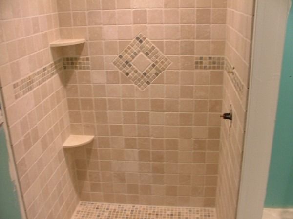 Tiled shower with a diamond mosaic inset and corner shelves