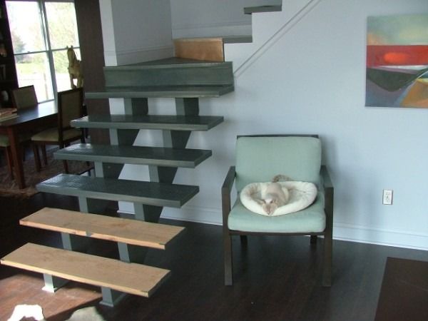Side view of open-riser stairs beside a dining area