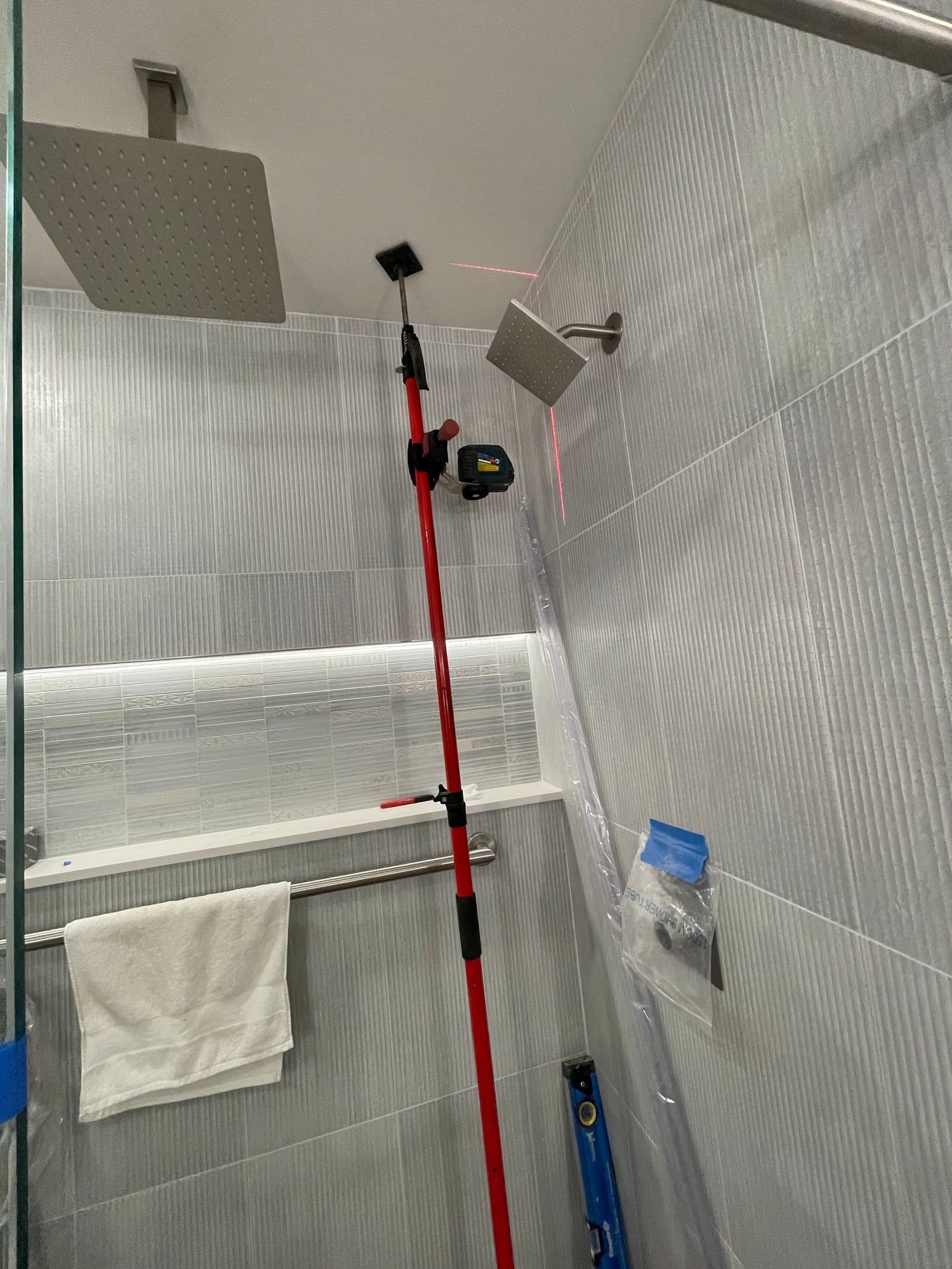 Laser line across shower tile during installation